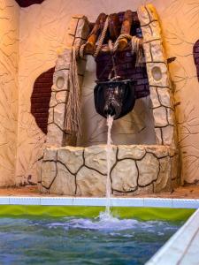 a water fountain in a pool in a water park at Iqama Al-Nakhlah in Ghardaïa