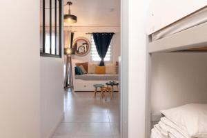 a bedroom with a bed and a table in a room at Appartement Ty Avel in Quiberon