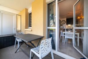 a table and chairs on the balcony of a house at Appartement Ty Avel in Quiberon +14 photos