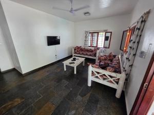 a living room with a couch and a tv at Daystar Villa in Watamu