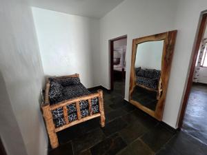 a room with a mirror and a bed in it at Daystar Villa in Watamu +13 photos