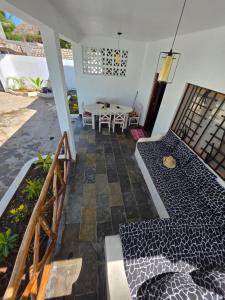 a living room with a table and a patio at Daystar Villa in Watamu
