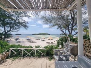 a view of a beach with umbrellas and the ocean at Daystar Villa in Watamu