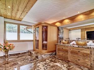 a bathroom with two sinks and wooden cabinets at Jagd Chalet in Leutasch