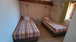 a room with two beds and two tables in it at Au Charme Charentais Gite geel in Blanzaguet-Saint-Cybard-le-Peyrat