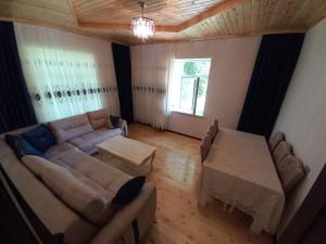a living room with a couch and a table at Naz in Lerik