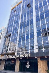 a hotel with a sign on the front of it at Terrazzo Hotel Campos dos Goytacazes in Campos dos Goytacazes