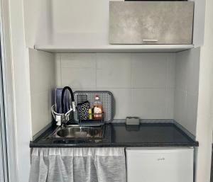 a kitchen counter with a sink in a kitchen at Studios Zafiri in Naxos Chora