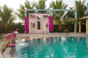 a swimming pool with a pink party set up at Lotus Resort in Raipur