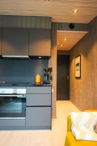 a kitchen with a stove top oven in a room at Modern One-Bedroom Apartment in Henningsvær in Henningsvær