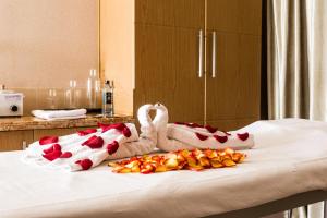 a bed with two swans and flowers on it at Royal Canaan Nairobi Hotel in Nairobi