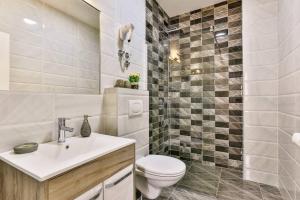a white bathroom with a toilet and a sink at Lux Apartmani Djukic in Bar