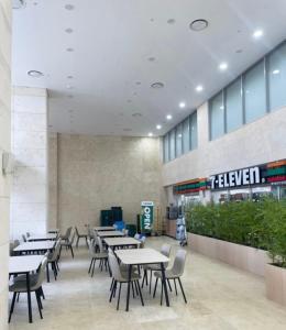 a restaurant with tables and chairs in a building at Yangyang Surfing Beach 18 in Saetchak