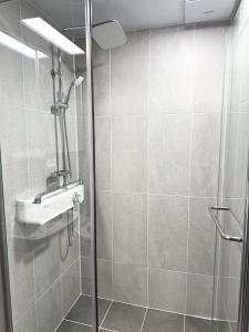 a shower with a sink and a glass shower door at Yangyang Surfing Beach 18 in Saetchak +6 photos