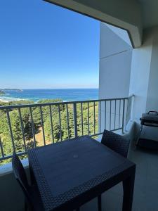 a balcony with a table and a view of the ocean at Yangyang Surfing Beach 18 in Saetchak