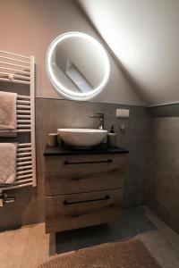 a bathroom with a sink and a mirror at Landhotel Villa Foresta Braunlage in Braunlage +113 photos