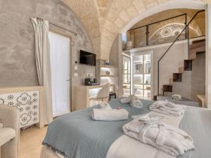 a bedroom with a blue bed with towels on it at SuiteCota24 piscina e spa in Lecce +99 photos