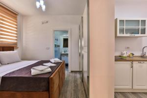 a bedroom with a bed with towels on it at Lux Apartmani Djukic in Bar