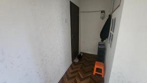 a hallway with a door and a small orange stool at Guest House 14th in Ulaanbaatar