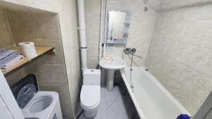 a bathroom with a sink and a toilet and a bath tub at Guest House 14th in Ulaanbaatar