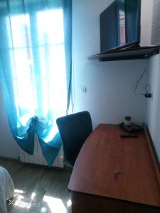 a room with a table and a chair and a window at Le Castel d'olmes in Laroque-dʼOlmes