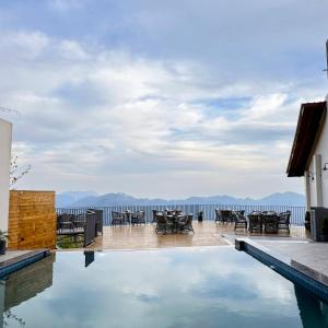 a house with a swimming pool with a view of the water at OREN Kasauli in Kasauli