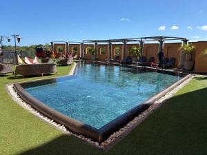 a large swimming pool on the roof of a hotel at Charming Duplex Mauritius' Little Venice in Terre Rouge