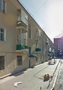 an empty street in front of a building at Guest House 14th in Ulaanbaatar