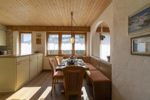 a kitchen with a dining room table and chairs at Chalet Stadel in Unterwasser