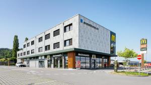 a building on the corner of a street at Anstatthotel Schafisheim - app self-check-in in Schafisheim