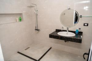 a bathroom with a sink and a mirror at Azure Guest House in Luxor +65 photos