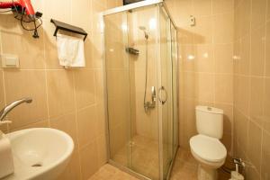 a bathroom with a shower and a toilet and a sink at kastro konak in Gokceada Town