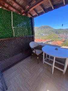 a table and chair in a room with a large window at kastro konak in Gokceada Town +3 photos