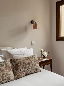 a bedroom with a bed and a table with a phone at Casa do Caneiro in Vila Real