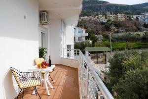 a balcony with a table and chairs and a view at Hotel SUNSET GL in Vlorë