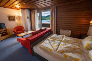 a bedroom with a bed and a large window at Haus Kapeller in Seeboden