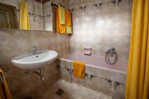 a bathroom with a sink and a bath tub at Haus Kapeller in Seeboden +19 photos