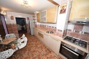 a kitchen with a sink and a stove top oven at Ket Apartments in Galaţi +11 photos