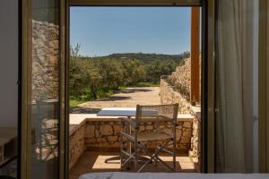 a chair sitting on the balcony of a house at Panorama Villa Sitia in Sitia