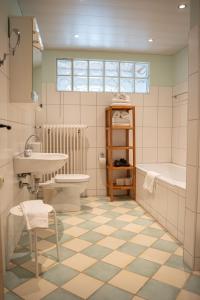 a bathroom with a sink and a toilet and a tub at Holzhauser Hof in Waldkraiburg +56 photos