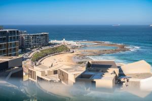 a view of a beach with buildings and the ocean at 1011 - First Light 2BR with Ocean Views - Prime Location in Newcastle