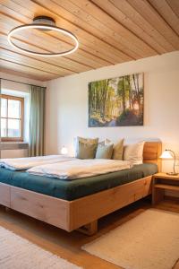 a bedroom with a large bed in a room at Holzhauser Hof in Waldkraiburg