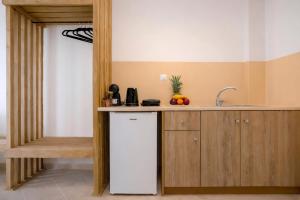 a kitchen with a white refrigerator and a counter at Nel Mare Studios in Laganas +17 photos
