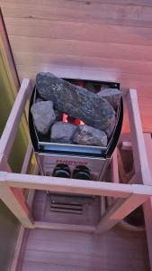 a shelf with rocks and a grill in a room at Casa Vacanza Zhurian in Ginestra