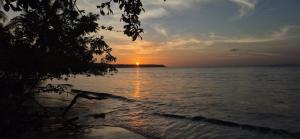 a sunset over the ocean with the sun setting on the horizon at Posada el arrecife in Nuquí