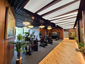 a gym with treadmills and elliptical machines at Hotel Platinia in Cluj-Napoca
