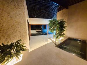 a room with a swimming pool and some plants at Hotel Platinia in Cluj-Napoca