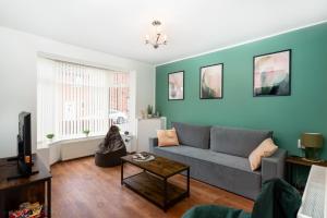 a living room with a couch and a table at 3 bed house, Free parking 9ppl in Pleasley