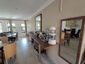 a room with a table with a coffee maker on it at Emakhaya B&B in Mthatha