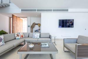 a living room with a couch and a coffee table at Tropical villa w pool & dock access u501 in Barú